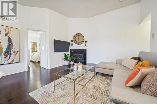 411 - 1370 Main Street E, Milton, ON - Indoor Photo Showing Living Room With Fireplace