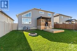 Enjoy the privacy of your fully fenced backyard, featuring a fire pit and Toja pergola. - 