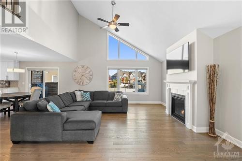 The living room boasts a cathedral ceiling. - 71 York Crossing, Russell, ON - Indoor Photo Showing Living Room With Fireplace