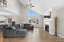 The living room boasts a cathedral ceiling. - 71 York Crossing, Russell, ON  - Indoor Photo Showing Living Room With Fireplace 