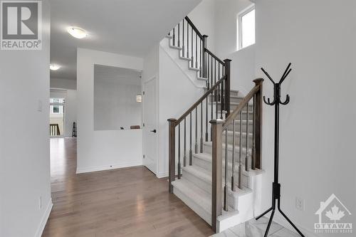 Gorgeous wood banister and hardwood floors. - 4527 Kelly Farm Drive, Ottawa, ON - Indoor Photo Showing Other Room