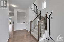 Gorgeous wood banister and hardwood floors. - 