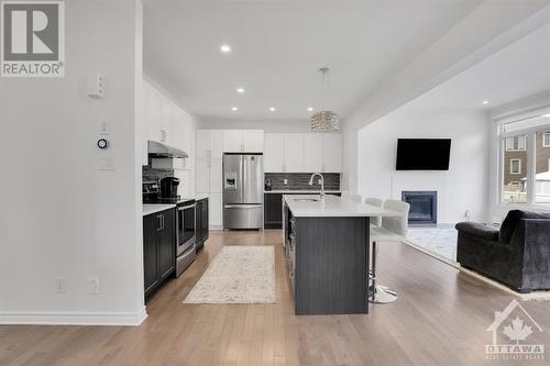 Pot lights and custom lighting. - 4527 Kelly Farm Drive, Ottawa, ON - Indoor Photo Showing Kitchen With Fireplace