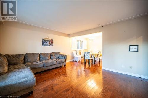 Living room with dark hardwood / wood-style floors and an inviting chandelier - 580 Highpoint Avenue Unit# Upper, Waterloo, ON - Indoor Photo Showing Living Room