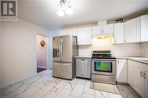 Kitchen with white cabinetry, decorative backsplash, and appliances with stainless steel finishes - 580 Highpoint Avenue Unit# Upper, Waterloo, ON - Indoor Photo Showing Kitchen