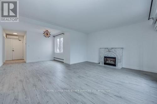 1St Fl - 18 Long Branch Avenue, Toronto, ON - Indoor Photo Showing Living Room With Fireplace