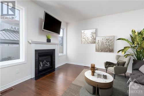 Virtually staged living room - 321 Everglade Way, Ottawa, ON - Indoor Photo Showing Living Room With Fireplace