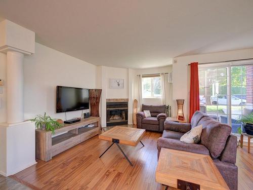 Salon - 101-270 Rue Des Violettes, Sainte-Thérèse, QC - Indoor Photo Showing Living Room With Fireplace