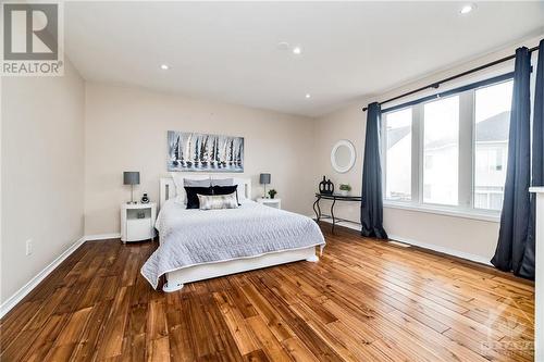 Primary bedroom with acacia wood floors - 26 Portadown Crescent, Ottawa, ON - Indoor Photo Showing Bedroom