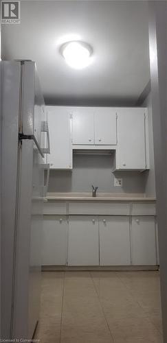 Kitchen featuring white refrigerator, sink, and white cabinets - 76 Brybeck Crescent Unit# 105, Kitchener, ON - Indoor