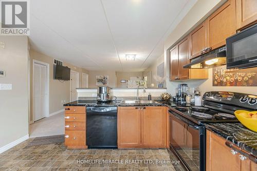 305 - 1380 Main Street E, Milton, ON - Indoor Photo Showing Kitchen With Double Sink