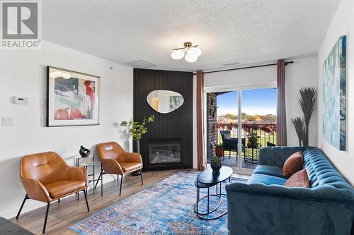 3160 Wildwood Unit# 412, Windsor, ON - Indoor Photo Showing Living Room With Fireplace