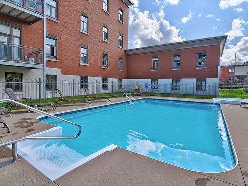 Pool - 413-2400 Av. De Lisieux, Québec (Beauport), QC - Outdoor With In Ground Pool With Exterior