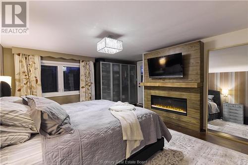 30 Allan Street, Coniston, ON - Indoor Photo Showing Bedroom With Fireplace