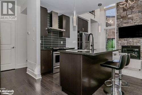 48 Carrick Trail, Gravenhurst, ON - Indoor Photo Showing Kitchen With Fireplace With Upgraded Kitchen