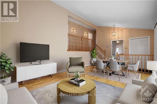 Photo is virtually staged. There's hardwood flooring underneath the carpet. The rendering is to give ideas on how it could be set up to allow for a dining area and living room area combination. - 1349 Bloomsbury Crescent, Ottawa, ON - Indoor Photo Showing Living Room