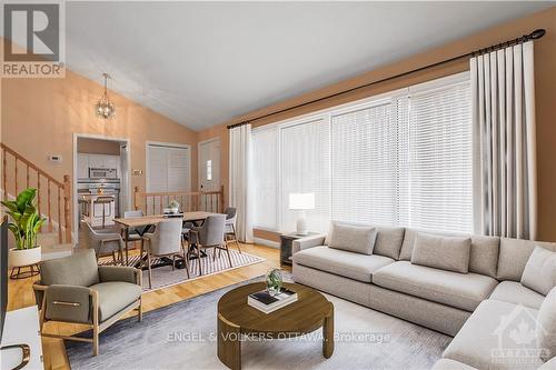 Photo is virtually staged. There's hardwood flooring underneath the carpet. The rendering is to give ideas on how it could be set up to allow for a dining area and living room area combination. - 1349 Bloomsbury Crescent, Ottawa, ON - Indoor Photo Showing Living Room