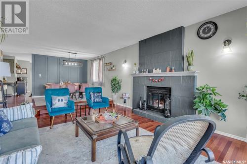 3230 Tufts Bay E, Regina, SK - Indoor Photo Showing Living Room With Fireplace