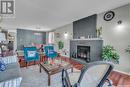 3230 Tufts Bay E, Regina, SK  - Indoor Photo Showing Living Room With Fireplace 