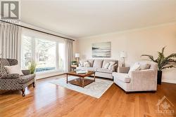 Living room with hardwood floors, wall to wall windows - 