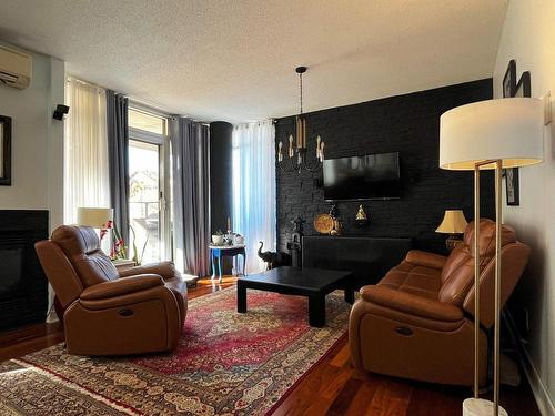 Salon - 102-700 Boul. Lucille-Teasdale, Terrebonne (Lachenaie), QC - Indoor Photo Showing Living Room With Fireplace