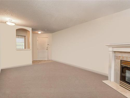 101-1580 Christmas Ave, Saanich, BC - Indoor Photo Showing Other Room With Fireplace