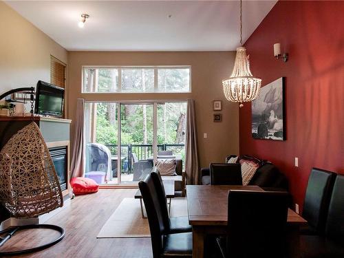 12-203 Boardwalk Blvd, Ucluelet, BC - Indoor Photo Showing Dining Room With Fireplace