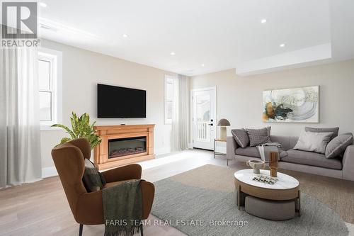 9 Bertram Drive, Springwater, ON - Indoor Photo Showing Living Room With Fireplace