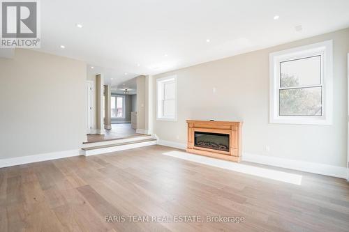 9 Bertram Drive, Springwater, ON - Indoor Photo Showing Living Room With Fireplace