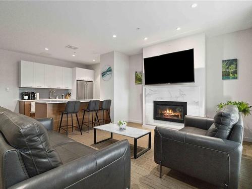 504-4009 Rainbow Hill Lane, Saanich, BC - Indoor Photo Showing Living Room With Fireplace