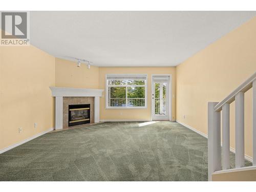 3825 Glen Canyon Drive Unit# 105, West Kelowna, BC - Indoor Photo Showing Living Room With Fireplace