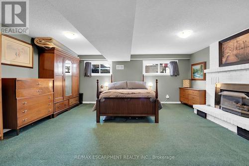 14 Northridge Drive, West Lincoln, ON - Indoor Photo Showing Bedroom With Fireplace