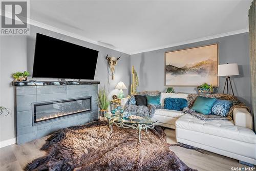 203 718 9Th Street E, Saskatoon, SK - Indoor Photo Showing Living Room With Fireplace