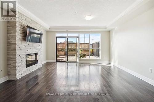 301 - 150 Wellington Street E, Guelph, ON - Indoor Photo Showing Living Room With Fireplace