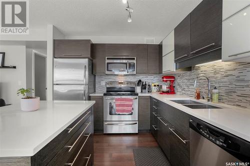 107 410 Ledingham Way, Saskatoon, SK - Indoor Photo Showing Kitchen With Stainless Steel Kitchen With Double Sink