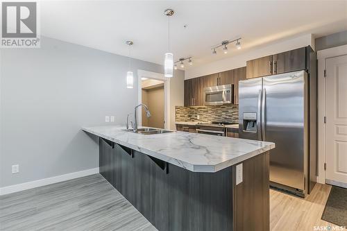 322 5301 Universal Crescent, Regina, SK - Indoor Photo Showing Kitchen With Stainless Steel Kitchen With Double Sink With Upgraded Kitchen