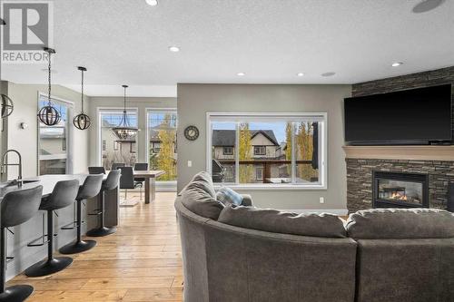 View of the main level from the office - 209 Hidden Creek Road Nw, Calgary, AB - Indoor Photo Showing Living Room With Fireplace