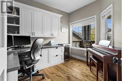 The office is complet with a built in desk and shaker style cabinetry - 