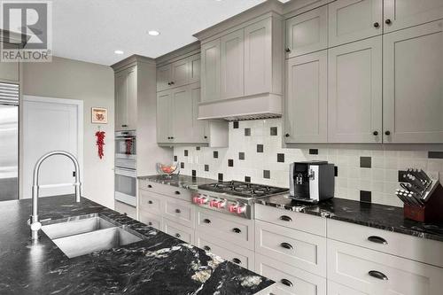 Amazing storage solutions in the abundance of shaker style full height cabinetry with pots and pan drawers - 209 Hidden Creek Road Nw, Calgary, AB - Indoor Photo Showing Kitchen With Double Sink With Upgraded Kitchen