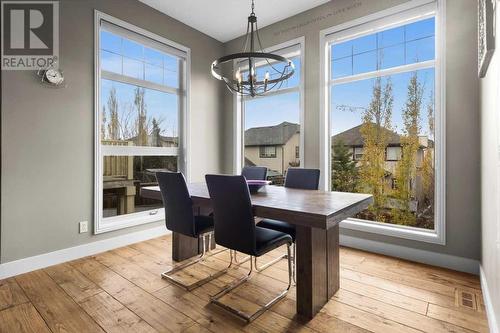 Spacious dining area is perfect for hosting dinner parties - 209 Hidden Creek Road Nw, Calgary, AB - Indoor Photo Showing Dining Room