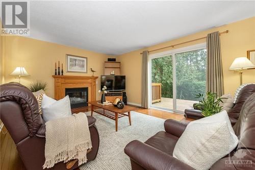 Family room with gas fireplace and patio doors - 40 Byrd Crescent, Kanata, ON - Indoor Photo Showing Living Room With Fireplace