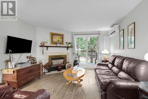 206 - 440 Wellington Street, St. Thomas, ON - Indoor Photo Showing Living Room With Fireplace