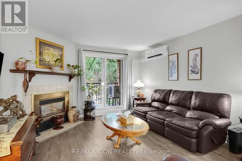 206 - 440 Wellington Street, St. Thomas, ON - Indoor Photo Showing Living Room With Fireplace