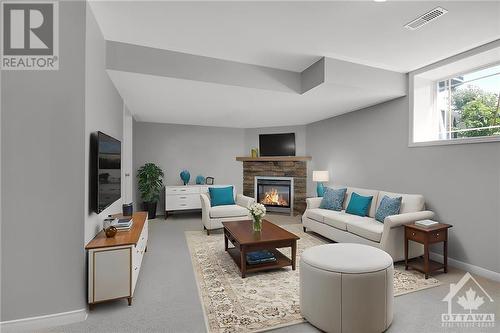 Virtually staged basement with lookout windows - 642 Pepperville Crescent, Ottawa, ON - Indoor Photo Showing Other Room With Fireplace