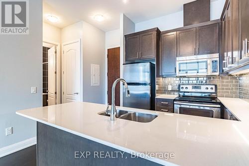 724 - 2480 Prince Michael Drive, Oakville, ON - Indoor Photo Showing Kitchen With Stainless Steel Kitchen With Double Sink With Upgraded Kitchen