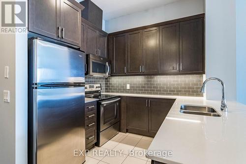 724 - 2480 Prince Michael Drive, Oakville, ON - Indoor Photo Showing Kitchen With Double Sink