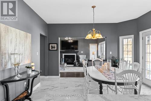 8670 Crayton Court, North Perth, ON - Indoor Photo Showing Dining Room With Fireplace