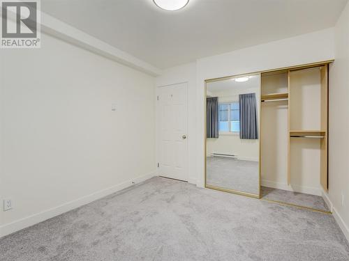 Second bedroom with new carpeting and built in closet organizer - 106 1110 Oscar St, Victoria, BC - Indoor Photo Showing Other Room