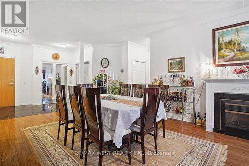 215 - 2085 Amherst Heights Drive, Burlington, ON - Indoor Photo Showing Dining Room With Fireplace