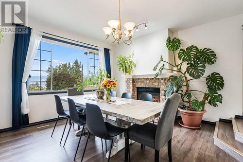 5115 Chute Lake Crescent, Kelowna, BC - Indoor Photo Showing Dining Room With Fireplace